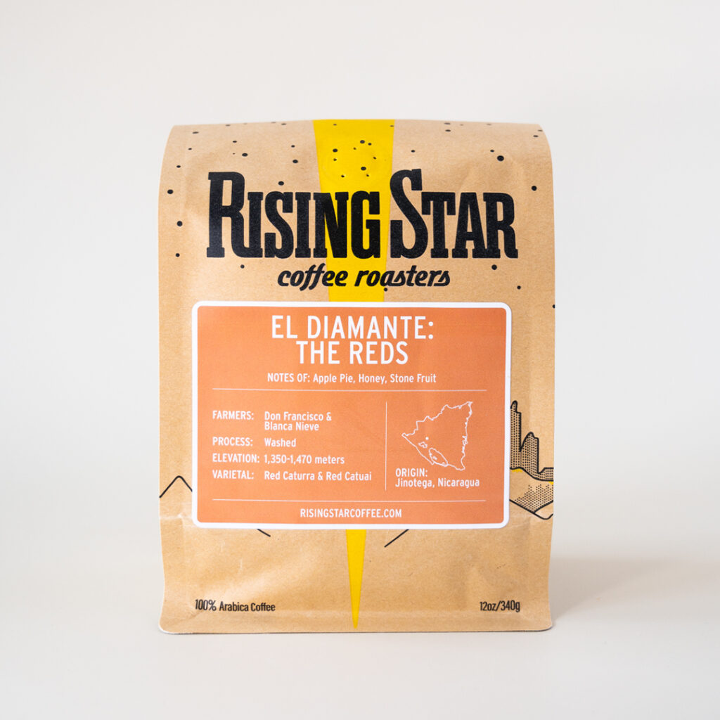 A Rising Star Coffee bag with a muted orange label that reads "El Diamante: The Reds". This Nicaraguan coffee has notes of Apple Pie, Honey, and Stone Fruit.