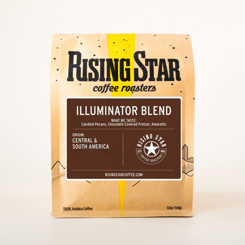 A bag of Rising Star Coffees Illuminator Blend. The label is brown with the region being Central and South America. The notes are Chocolate Covered Pretzel, Candied Pecans and Amaretto.