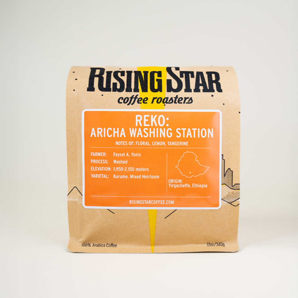 A bag of rising star coffee beans called Reko Aricha Washing station. The label is orange.