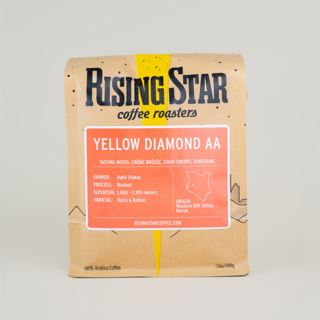 A bag of Rising Star Coffee called Yellow Diamond. The orange sticker has the notes as Creme Brulee, Sour Cherry, Tangerine,