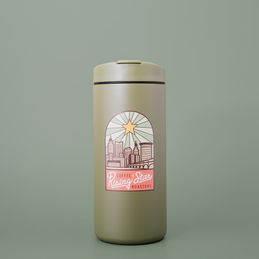 A green tumbler from Miir with art of the Cleveland Skyline.