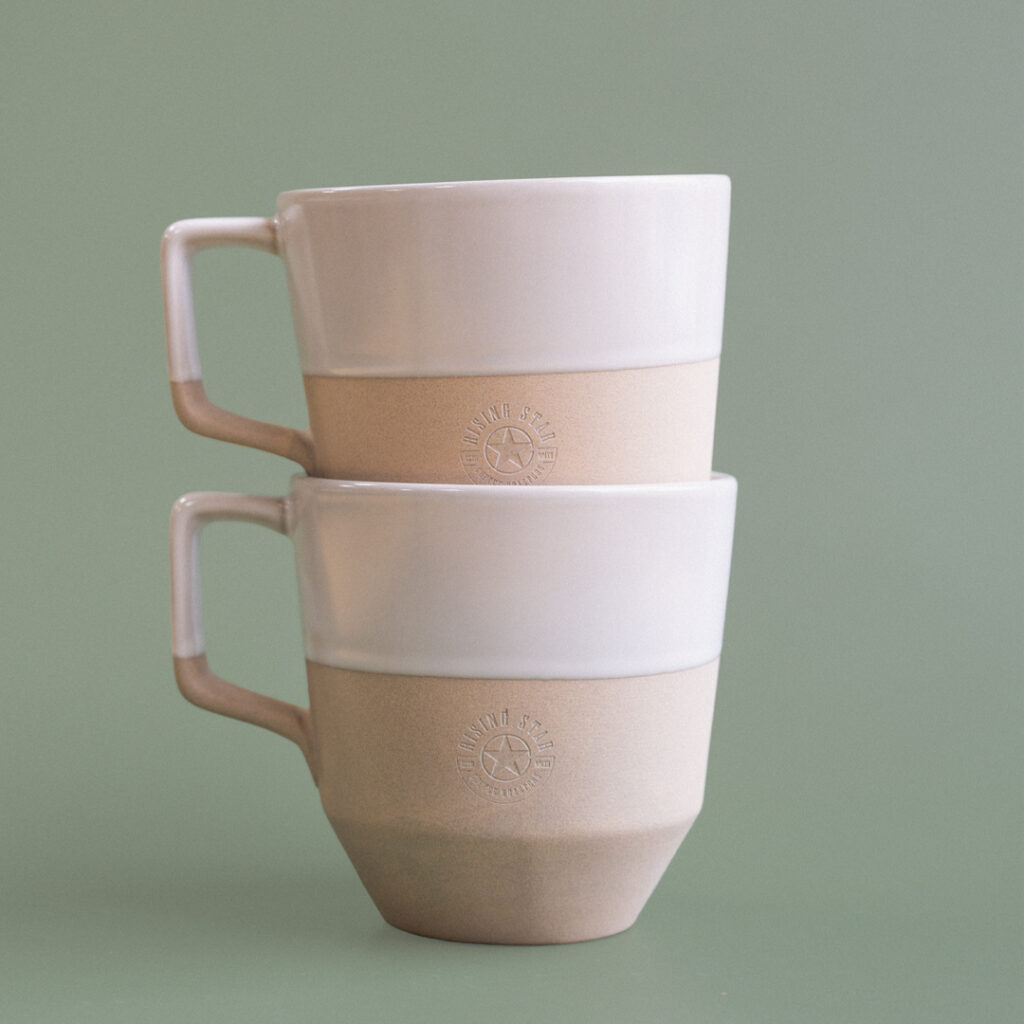 A photo of the stacked natural notneutral mugs.